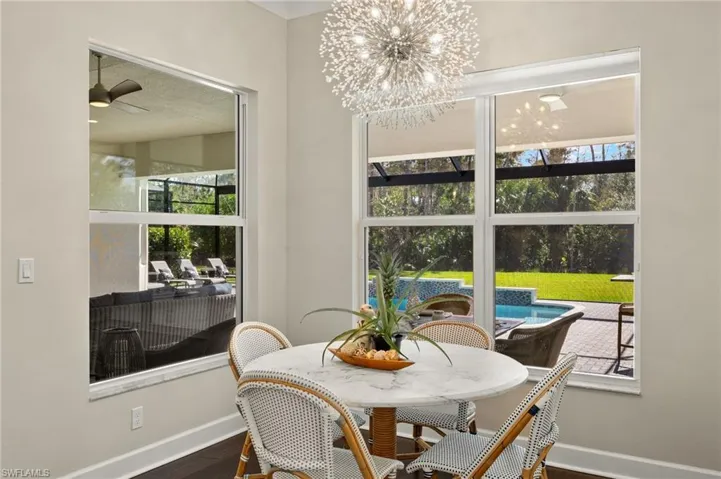 Dining area with ceiling fan and wood-type flooring