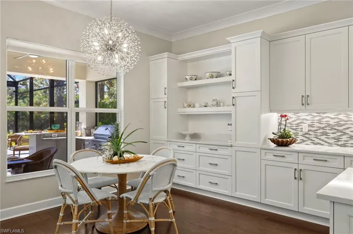 Dining room featuring a chandelier, crown molding, and dark hardwood / wood-style flooring