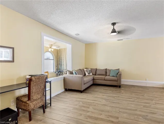 Living room with hobby room through cut out