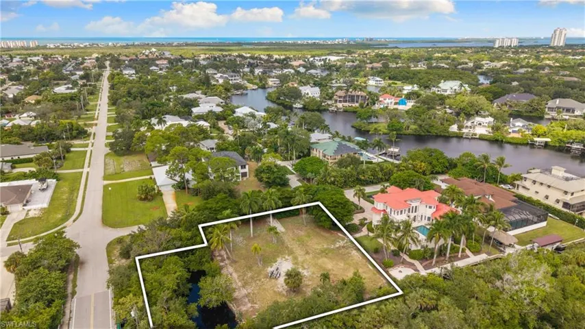 Waterfront lot featuring mature trees and canal access