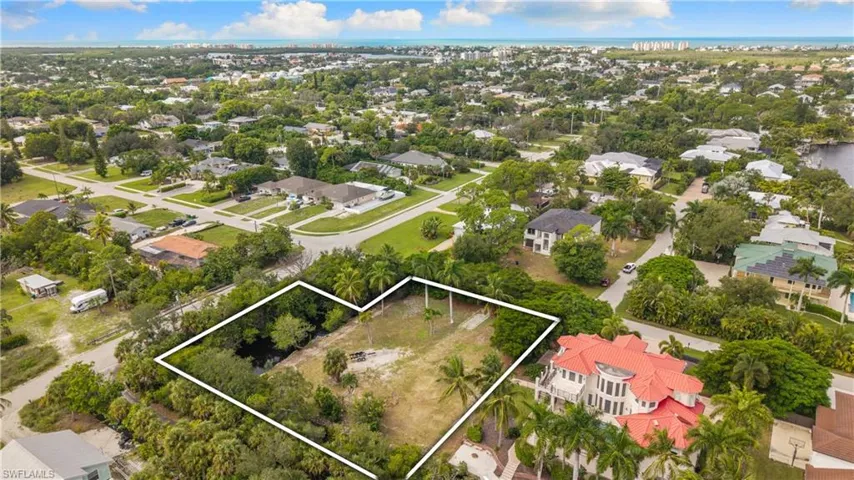 Cleared land parcel with mature trees and established street access