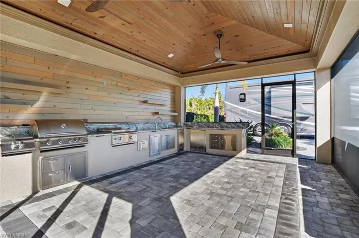 View of patio / terrace with area for grilling and a ceiling fan