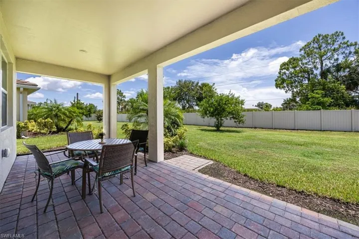 Fenced backyard featuring a patio and outdoor dining area