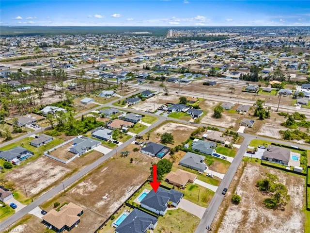Aerial overview of property's location featuring nearby suburban area