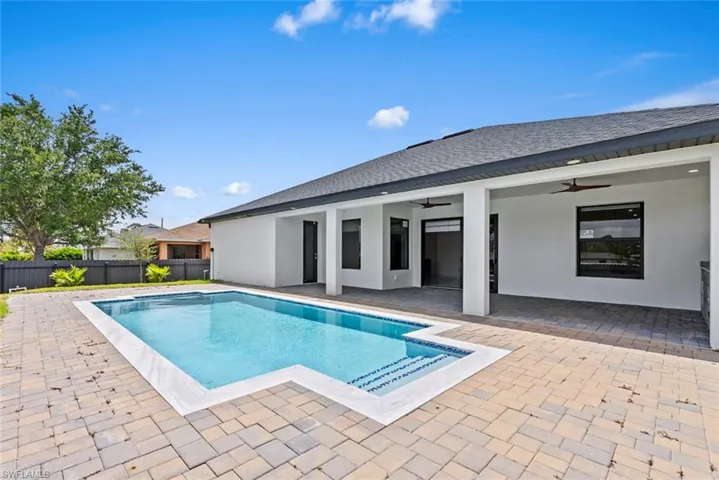 View of pool with a ceiling fan and a patio