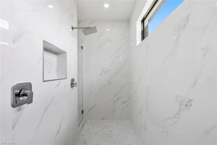 Full bath featuring a marble finish shower
