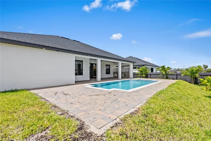 View of pool with a patio, a fenced backyard, and ceiling fan