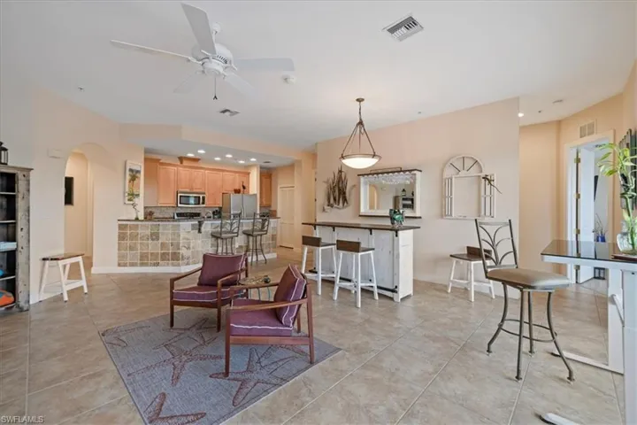 Dining area with ceiling fan and light tile patterned floors