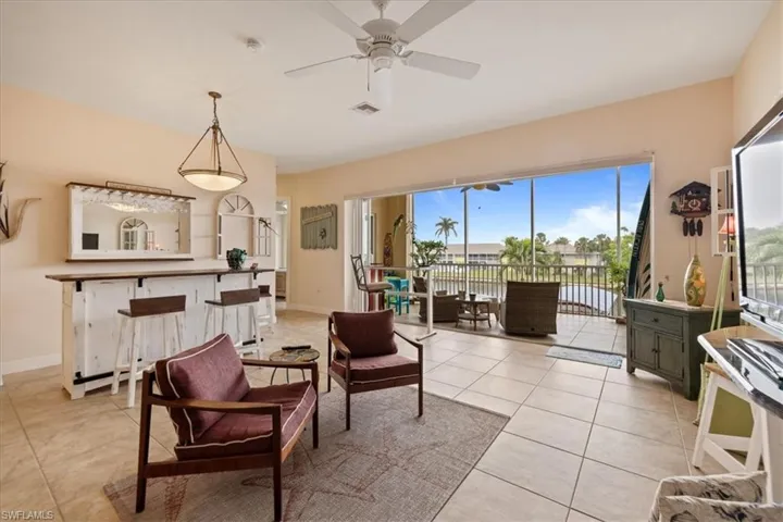 Sitting room featuring ceiling fan and light tile patterned floors