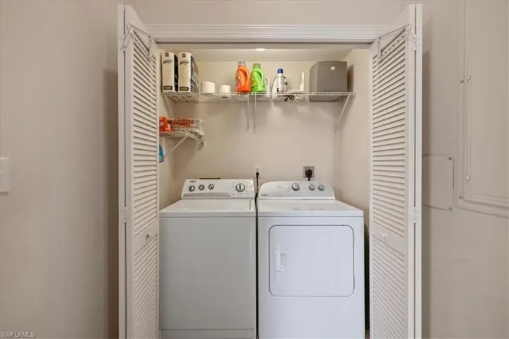 Washroom featuring washer and clothes dryer