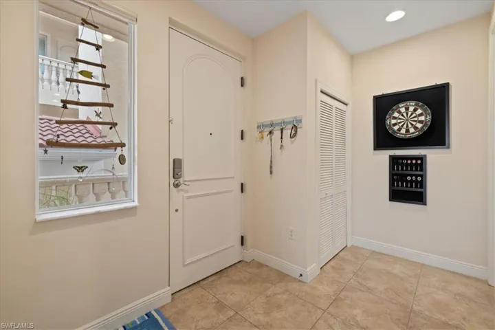 Doorway with light tile patterned floors