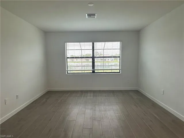 Spare room featuring dark hardwood / wood-style flooring