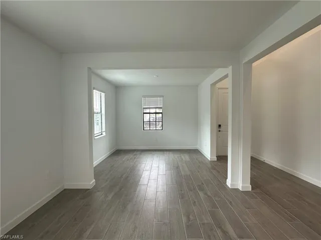 Unfurnished living room with dark hardwood / wood-style flooring