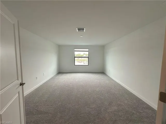 Empty room with carpet flooring