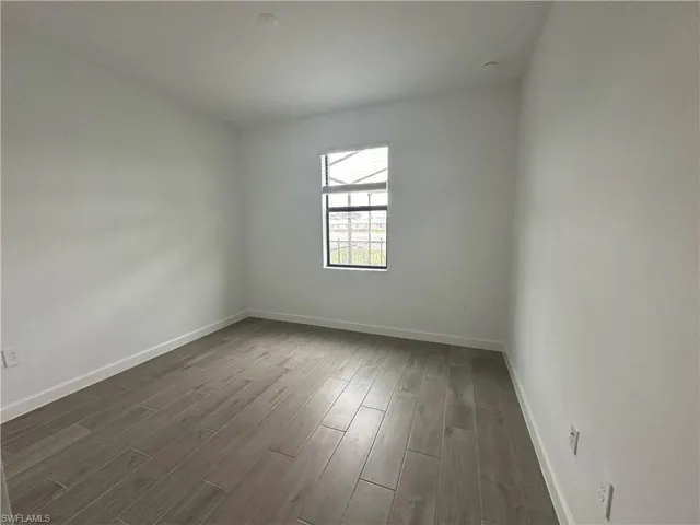 Unfurnished room featuring hardwood / wood-style flooring