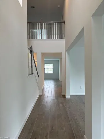 Entrance foyer with a high ceiling and dark hardwood / wood-style floors