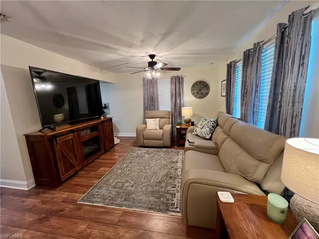 Living room featuring luxury vinyl plank flooring and ceiling fan