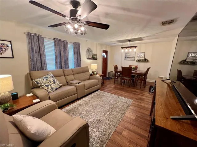 Living room with  luxury vinyl plank flooring and ceiling fan