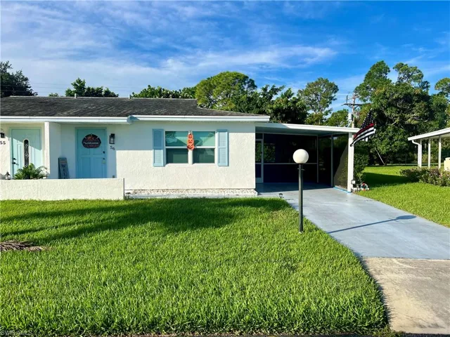 Condo/Villa with a front lawn and a carport with stucco exterior