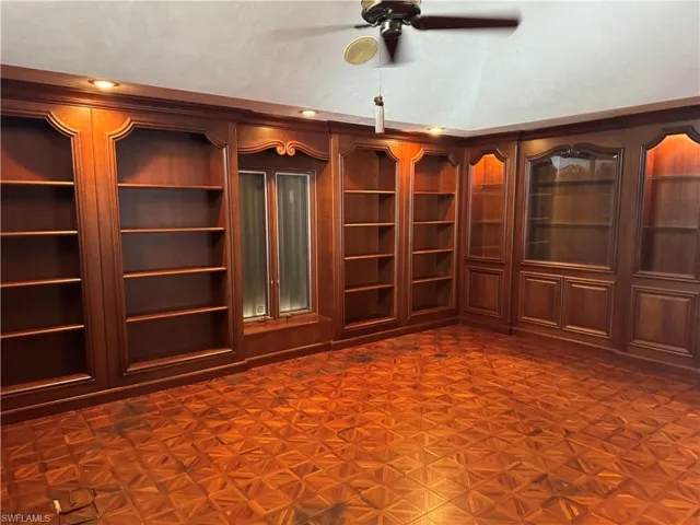Unfurnished room with lofted ceiling and a ceiling fan