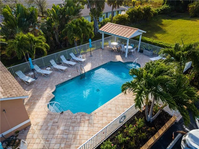 Community pool featuring a patio and outdoor dining space