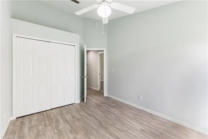 2nd bedroom featuring light wood-type flooring, a closet, and ceiling fan