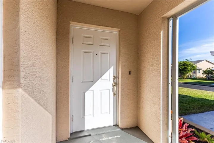 Property entrance featuring private screened porch