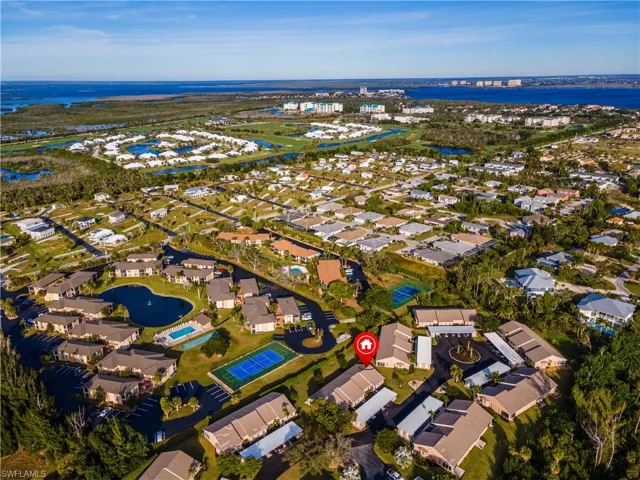 Aerial view of property and surrounding area featuring nearby suburban area