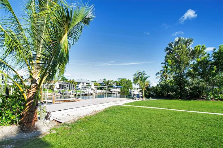 View of yard featuring a water view and a dock