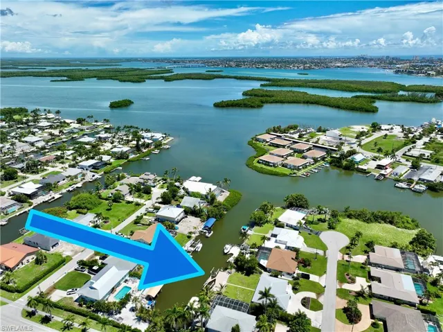 Birds eye view of property with a water view