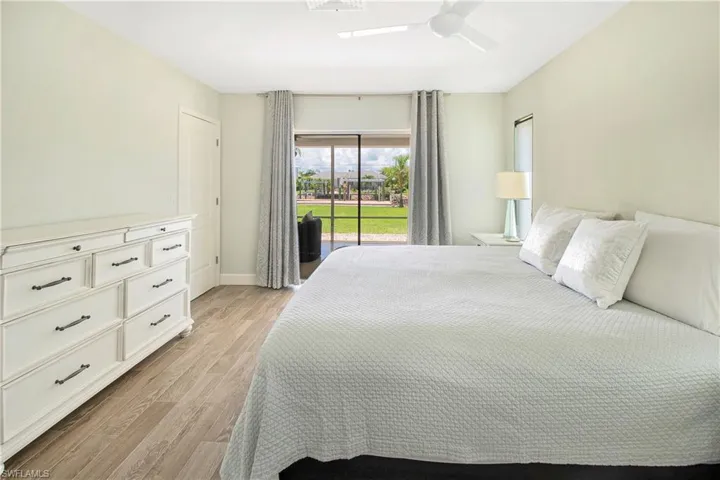 Bedroom with ceiling fan, light hardwood / wood-style flooring, and access to outside