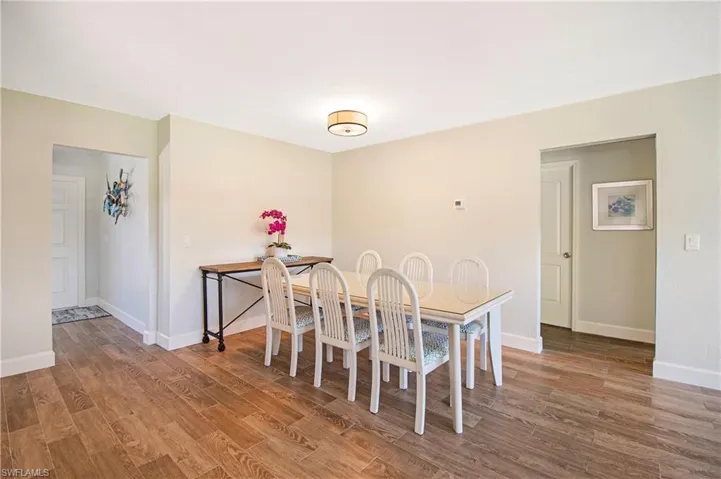 Dining area with hardwood / wood-style tile flooring