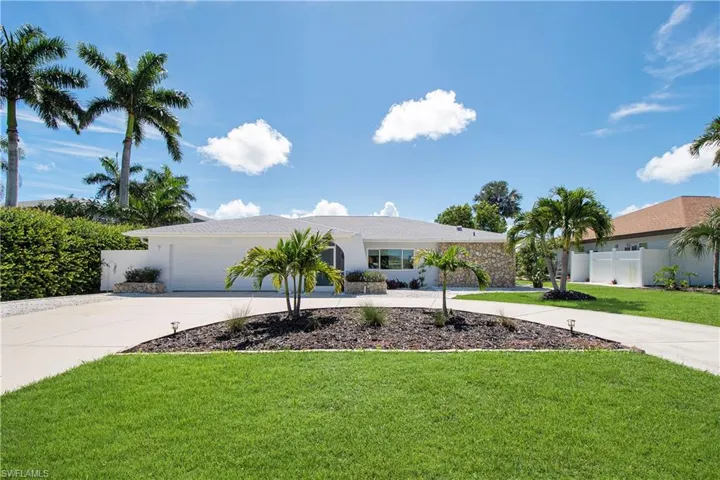 Single story home featuring a front yard and a garage