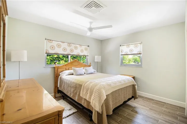 Bedroom featuring ceiling fan and wood-type flooring