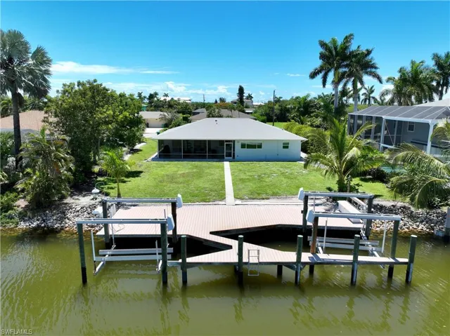 Dock area featuring a yard and a water view