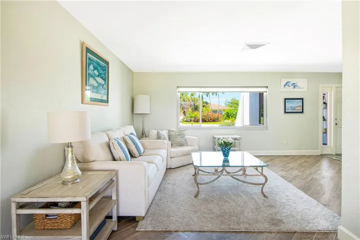 Living room featuring wood-type tile flooring