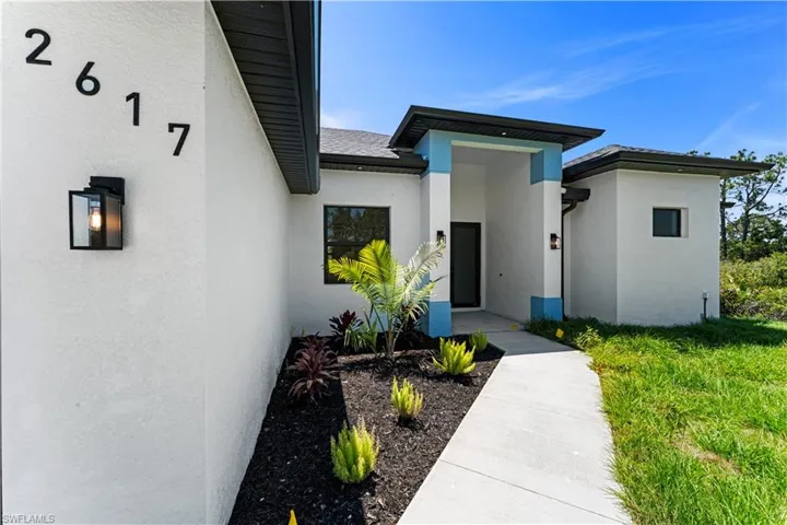 Entrance to property with stucco siding