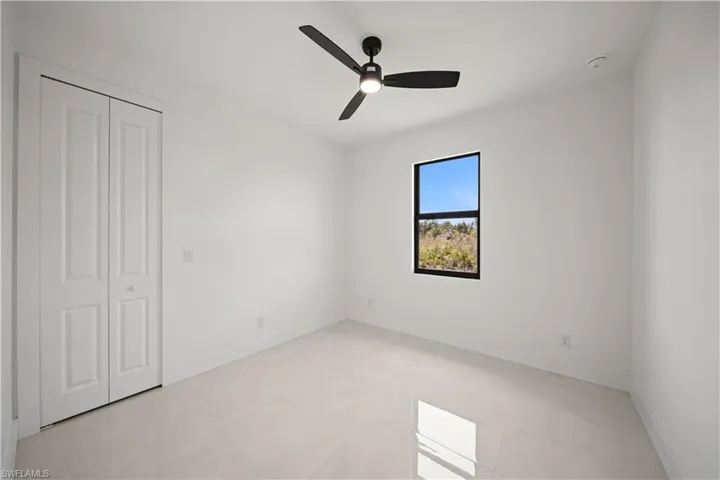 Unfurnished bedroom with baseboards and a ceiling fan