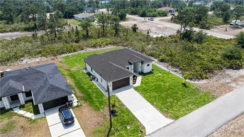 View from above of property featuring a tree filled landscape