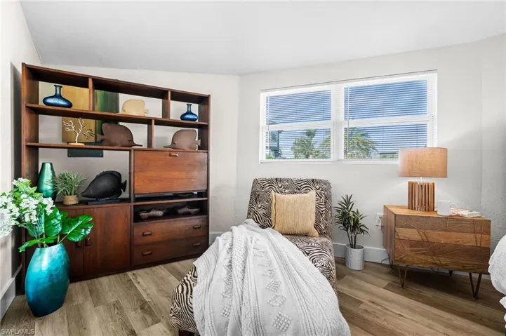 Bedroom with light wood finished floors and baseboards