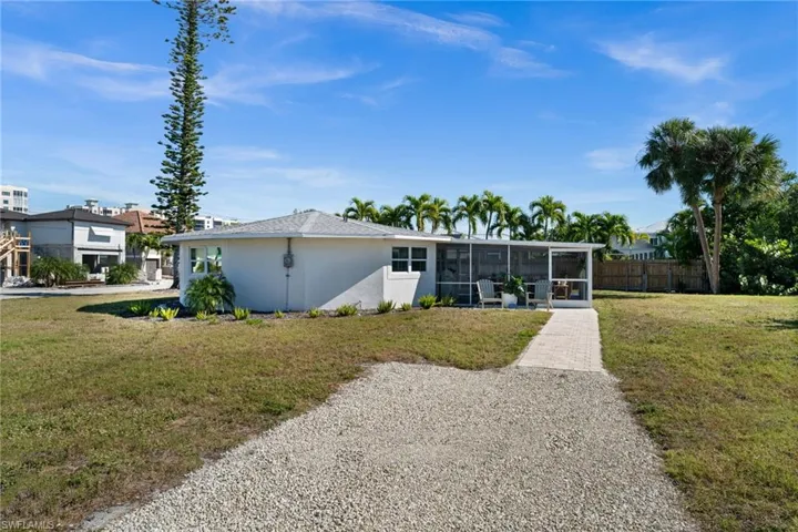Back of property featuring a sunroom and stucco siding