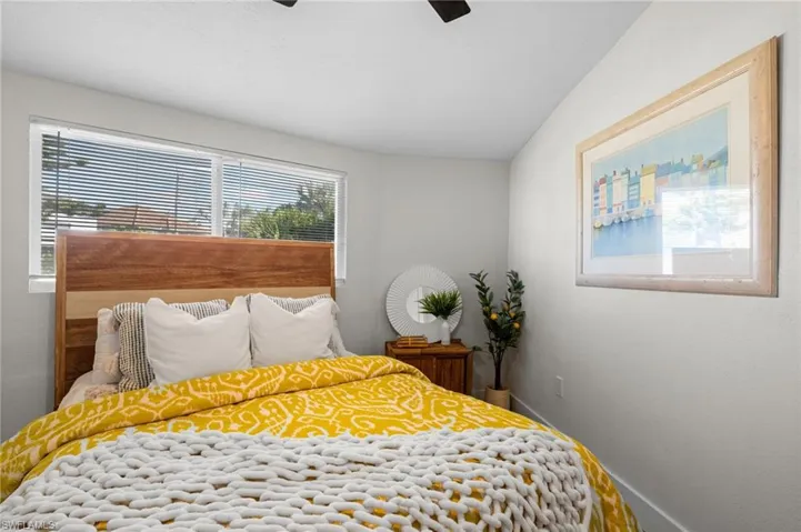 Bedroom featuring lofted ceiling and a ceiling fan