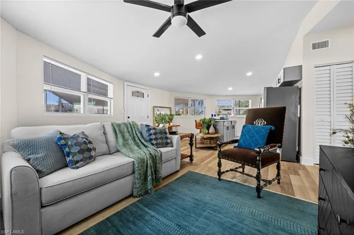 Living room featuring a ceiling fan, wood finished floors, and recessed lighting