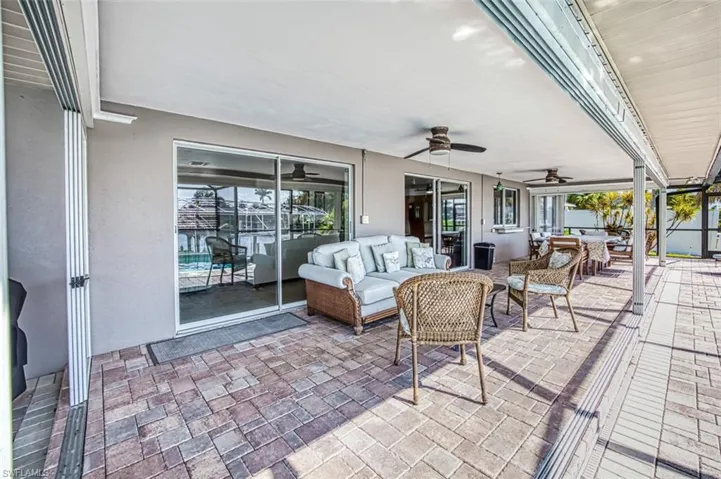 View of terrace with ceiling fan and an outdoor hangout area