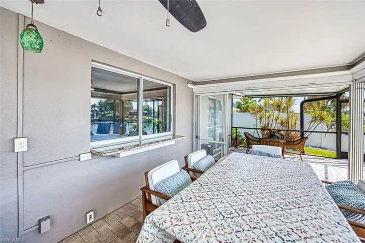 Tiled dining space featuring ceiling fan