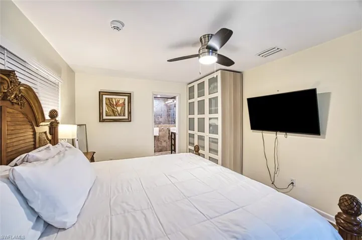 Bedroom with connected bathroom and ceiling fan