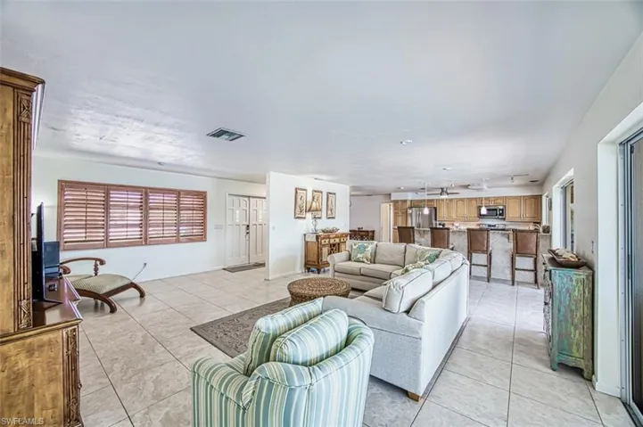 Living room with plenty of natural light and light tile floors