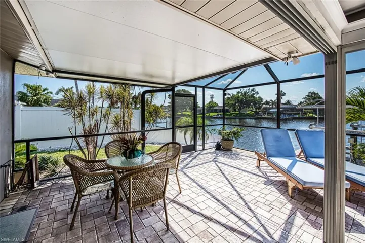 Unfurnished sunroom featuring a water view