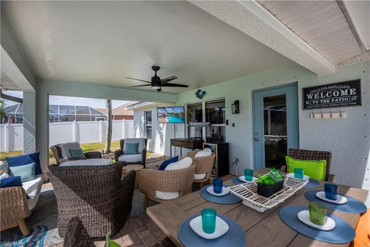 View of patio with ceiling fan and an outdoor living / dining area