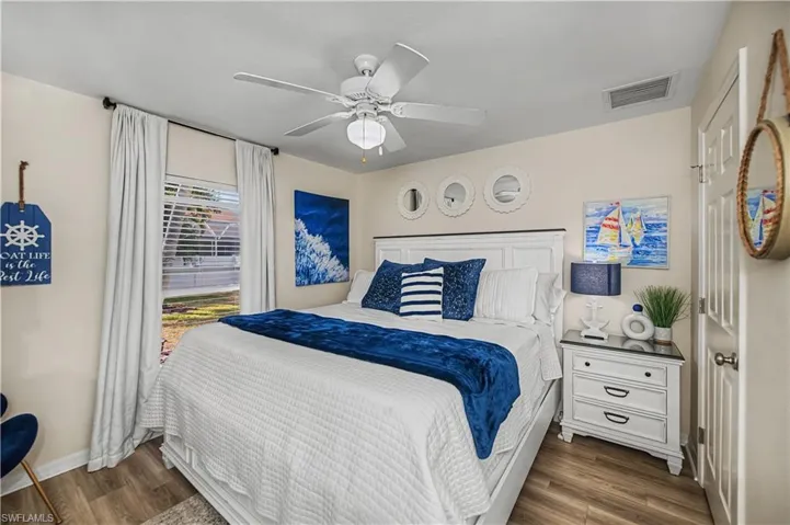 Bedroom featuring ceiling fan and dark wood-style floors